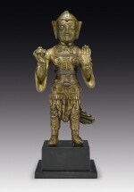A COPPER ALLOY FIGURE OF A GUARDIAN WITH COPPER INLAY,  TIBET, 13TH CENTURY