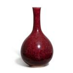 A copper-red-glazed bottle vase, Qing dynasty | 清 紅釉長頸瓶