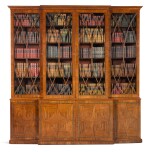 A Regency brass inlaid and ebony strung mahogany breakfront library bookcase, circa 1815