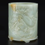 An exceptional white and russet jade brushpot, Qing dynasty, Qianlong period | 清乾隆 白玉雕進寶圖筆筒