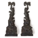 A PAIR OF CARVED EBONIZED WOOD DOLPHIN BRACKETS