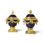 A pair of Louis XVI style gilt-bronze mounted blue porcelain vases and covers, after the model by Jean Dulac, late 19th century
