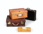 Lot comprising a leather suitcase, an alligator suitcase, a leather vanity suitcase and a little leather trunk