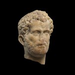 A ROMAN MARBLE RELIEF PORTRAIT HEAD OF A MAN, ANTONINE, PROBABLY EASTERN MEDITERRANEAN, CIRCA A.D. 140-150