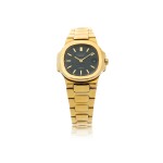 REFERENCE 4700/1 NAUTILUS RETAILED BY TIFFANY & CO.: A LADY'S YELLOW GOLD BRACELET WATCH WITH DATE, CIRCA 1985