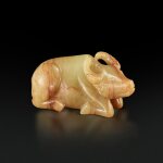 A small yellow and russet jade figure of a recumbent buffalo, 17th century |  十七世紀 黄玉臥牛