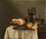 Still life with a glass roemer, façon-de-venise wineglass, silver cup, half-cut ham and bread roll with pewter plates, all on a draped table