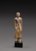 An Egyptian Wood Figure of a Man, 6th Dynasty, reign of Pepi II, circa 2246-2152 B.C.