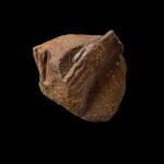 An Egyptian Quartzite Fragment of a Naophorous Statue, New Kingdom, 1550-1075 B.C.