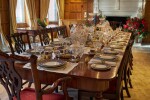 An early 19th C Mahogany Dining Table by Gillow & Co. with a set of 12 carved Dining Chairs in the Chippendale Style, and a Thomas Goode 'Stewart' bone china part dinner and dessert service, and an original antique glass from the Thomas Goode archive, various dates