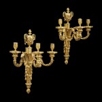 A LARGE PAIR OF LOUIS XVI GILT BRONZE THREE-BRANCH WALL LIGHTS IN THE MANNER OF PHILIPPE CAFFIÉRI, CIRCA 1775