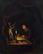 Young man drawing by candlelight