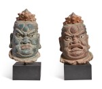 A LARGE PAIR OF POLYCHROMED STUCCO HEADS OF BUDDHIST GUARDIANS,  YUAN / MING DYNASTY