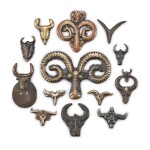 A group of 13 copper-alloy 'bovine', 'ram' and 'yak' thogchags, Tibet, 12th - 15th century 十二至十五世紀 西藏 聖羊及聖牛首紋天鐵一組十三件