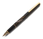 NAMIKI |  A BLACK LACQUER AND GOLD PLATED ACCENTS, DEPICTING A CRANE, CIRCA 2000