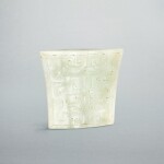 A pale celadon jade 'mask' scabbard chape,  Eastern Zhou dynasty, Warring States period - Western Han dynasty | 東周戰國至西漢 青白玉獸面紋劍珌