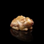 A white and russet jade figure of a mythical tapir, Ming dynasty or earlier 明或更早 白玉臥貘