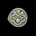 A reticulated white jade belt plaque, Ming dynasty, 16th/17th century | 明十六/十七世紀 白玉鏤雕壽桃紋帶板