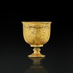 A small finely engraved gilt-bronze 'hunting' stem cup, Tang dynasty | 唐 鎏金銅鏨花狩獵紋高足小盃