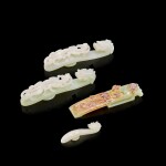 Three white jade belt hooks and a pale celadon and russet jade scabbard slide, Qing dynasty, 18th century 清十八世紀 白玉帶鉤三件及青白玉劍璏一件