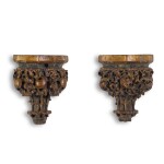 A pair of polychrome and parcel-gilt carved oak wall brackets, probably English, 15th century