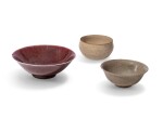 A red-glazed flared bowl, Qing dynasty, 18th century, and two cream white-glazed bowls, The red-glazed bowl | 清十八世紀 紅釉盌 及 陶瓷盌 一組三件