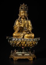 A large gilt-bronze figure of Avalokiteshvara and lotus pedestal, late Ming dynasty