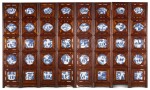 A large eight-fold Hongmu screen inset with forty blue and white shaped plaques The plaques Qing dynasty, 18th century, the wood screen 20th century | 瓷板為清十八世紀，后被配為屏風 青花瓷板八開屏風