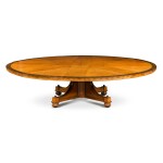A late Victorian amboyna and mahogany circular expanding dining table by Waring and Gillows, early 20th century and later