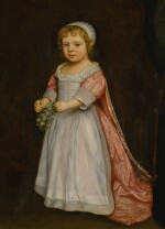 Portrait of a young girl holding grapes