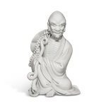 A 'Dehua' figure of a luohan, 20th century | 二十世紀 德化白釉羅漢坐像