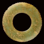 A GREEN JADE NOTCHED DISC, BI NEOLITHIC PERIOD, JIANG-HUAI REGION | 新石器時代江淮地區 青玉齒牙璧