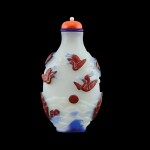 A cinnabar-red and blue overlay glass 'cranes' snuff bottle, Yangzhou school, Qing dynasty, 19th century | 清十九世紀 揚州作涅白地套雙色料瑞鶴紋鼻煙壺