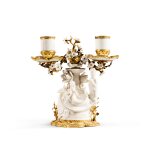 A Louis XV gilt-bronze mounted Chinese porcelain two-light candelabra, Kangxi period (1622-1722), circa 1750 | Candélabre à deux lumières en porcelaine blanc de Chine d'époque Kangxi (1622-1722) et monture de bronze doré d'époque Louis XV, vers 1750