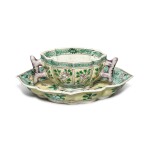 A famille-verte biscuit 'floral' quatrefoil cup and saucer, Qing dynasty, Kangxi period | 清康熙 素三彩花卉紋海棠式盃碟一套