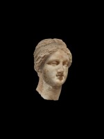 A Marble Head of a Woman, perhaps a Goddess, Hellenistic or early Roman, circa 2nd century B.C.