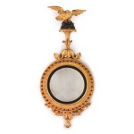 A REGENCY EBONISED AND GILTWOOD CONVEX MIRROR, EARLY 19TH CENTURY