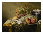 LAURENS CRAEN  |  A STILL LIFE WITH A POMEGRANATE AND OTHER FRUITS, OYSTERS, SHRIMPS AND SHELLS ON A VELVET BOX ON A TABLE