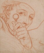 Portrait of a man looking through a magnifying glass