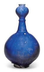 AN INTACT KASHAN BLUE-GLAZED BOTTLE VASE, PERSIA, 12TH/13TH CENTURY