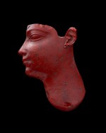 AN EGYPTIAN RED GLASS INLAY HEAD, 30TH DYNASTY/EARLY PTOLEMAIC PERIOD, CIRCA 380-250 B.C.
