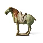 A green-and amber-glazed pottery figure of a horse, Tang dynasty | 唐 綠釉褐彩馬