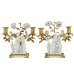 A pair of Régence gilt-bronze mounted Chinese blanc de chine porcelain two-light candelabra, the porcelain 18th century, the mounts circa 1730