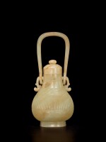 A celadon and russet jade archaistic hanging vase and cover, 17th century or earlier | 十七世紀或更早 青玉雕仿古提梁卣