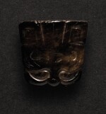 A SMALL BLACK JADE CARVING OF A TAOTIE MASK PENDANT SHANG DYNASTY OR LATER | 商或以後 玉饕餮紋珮