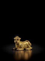 A gilt-bronze 'mythical beast' weight, Ming dynasty | 明 銅鎏金瑞獸形鎮