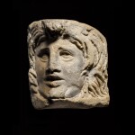 A Roman Marble Relief Theatre Mask, 3rd Century A.D.