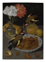 CIRCLE OF GEORG FLEGEL | STILL LIFE OF A ROLL, GLASS VASE OF CARNATIONS, AN ORANGE, WALNUTS, AND A BOWL OF ALMONDS WITH GOLDFINCHES