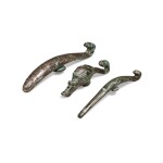 A group of three silver-inlaid bronze belt hooks, Warring States period - Han dynasty | 戰國至漢 銅錯銀帶鉤一組三件