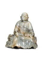 A celadon and russet soapstone figure of a seated scholar, Qing dynasty, first half of the 19th century